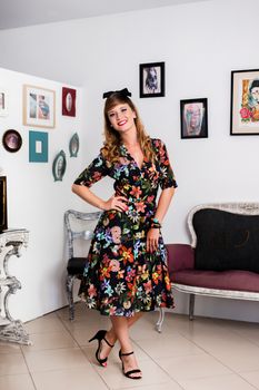 Woman posing with a vintage style retro floral clothing.