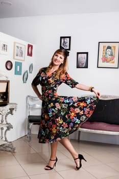 Woman posing with a vintage style retro floral clothing.