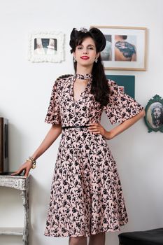 Woman posing with a vintage style retro floral clothing.