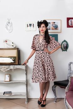 Woman posing with a vintage style retro floral clothing.