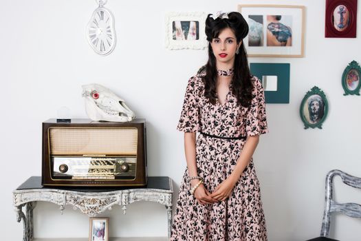 Woman posing with a vintage style retro floral clothing.