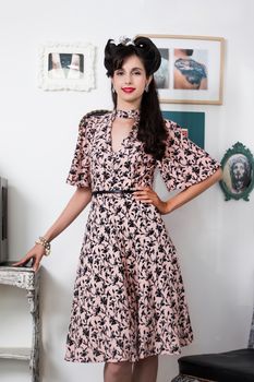 Woman posing with a vintage style retro floral clothing.