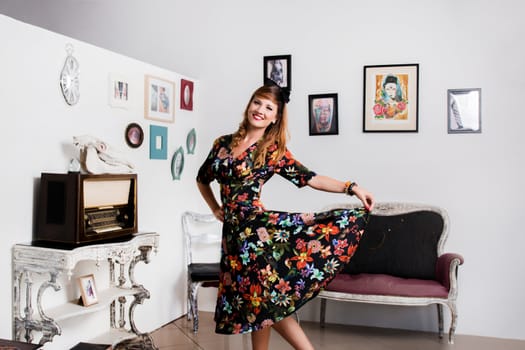 Woman posing with a vintage style retro floral clothing.