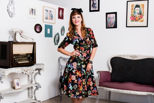 Woman posing with a vintage style retro floral clothing.
