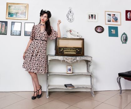 Woman posing with a vintage style retro floral clothing.