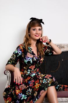 Woman posing with a vintage style retro floral clothing.