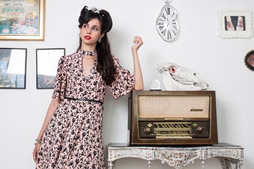 Woman posing with a vintage style retro floral clothing.