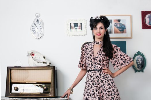 Woman posing with a vintage style retro floral clothing.