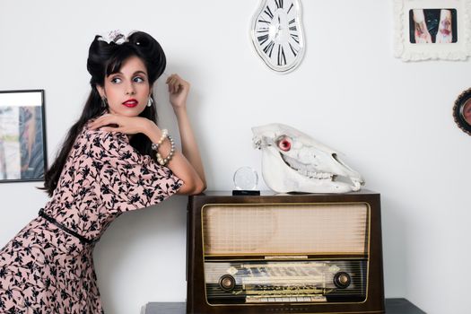 Woman posing with a vintage style retro floral clothing.