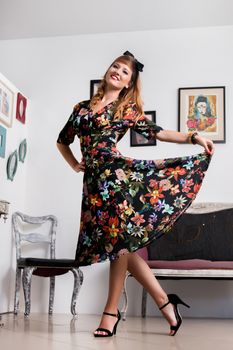 Woman posing with a vintage style retro floral clothing.