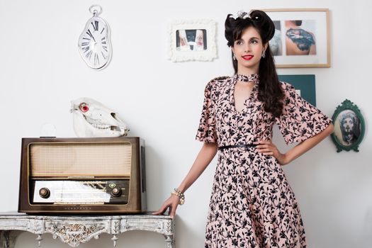 Woman posing with a vintage style retro floral clothing.