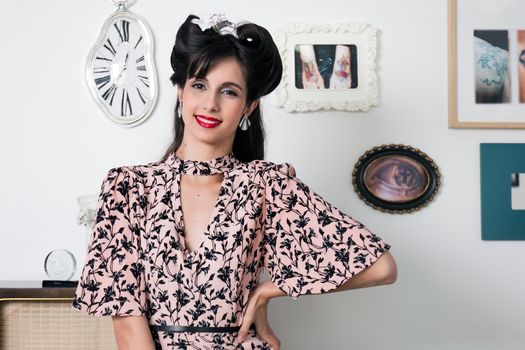 Woman posing with a vintage style retro floral clothing.