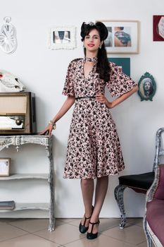 Woman posing with a vintage style retro floral clothing.