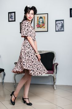 Woman posing with a vintage style retro floral clothing.