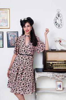 Woman posing with a vintage style retro floral clothing.