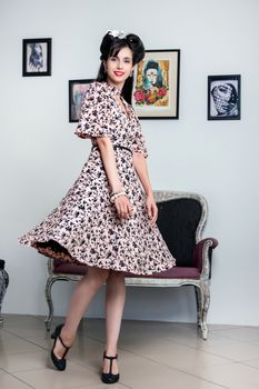 Woman posing with a vintage style retro floral clothing.