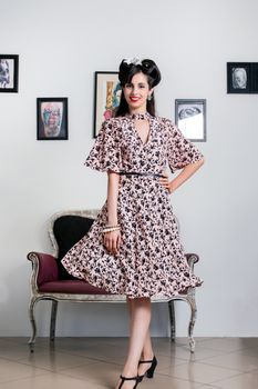 Woman posing with a vintage style retro floral clothing.