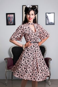 Woman posing with a vintage style retro floral clothing.