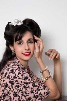 Woman posing with a vintage style retro floral clothing.