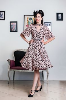 Woman posing with a vintage style retro floral clothing.