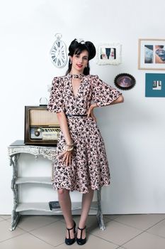 Woman posing with a vintage style retro floral clothing.