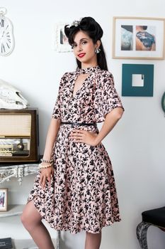 Woman posing with a vintage style retro floral clothing.