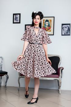 Woman posing with a vintage style retro floral clothing.