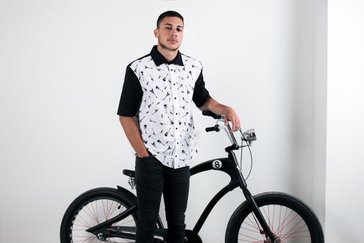 Teenager posing with a vintage style retro clothing and a bike.