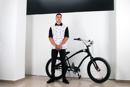 Teenager posing with a vintage style retro clothing and a bike.