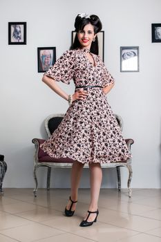 Woman posing with a vintage style retro floral clothing.