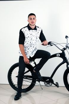 Teenager posing with a vintage style retro clothing and a bike.