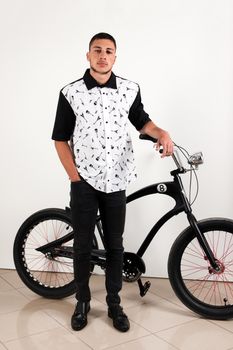 Teenager posing with a vintage style retro clothing and a bike.