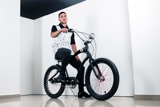 Teenager posing with a vintage style retro clothing and a bike.