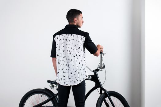 Teenager posing with a vintage style retro clothing and a bike.