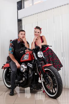 Close up of a couple using vintage clothing on a motorbike.