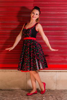 Woman posing with a vintage style retro floral clothing.