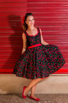 Woman posing with a vintage style retro floral clothing.