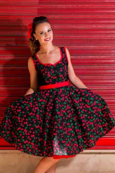 Woman posing with a vintage style retro floral clothing.