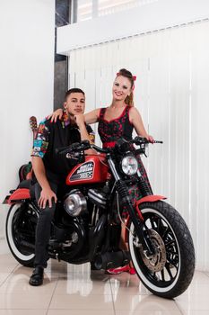 Close up of a couple using vintage clothing on a motorbike.