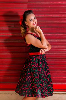 Woman posing with a vintage style retro floral clothing.