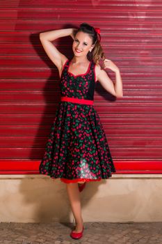 Woman posing with a vintage style retro floral clothing.