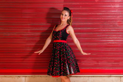 Woman posing with a vintage style retro floral clothing.