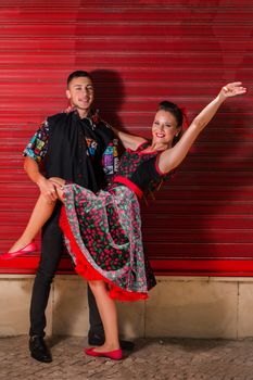 Vintage couple dancing over a red background.