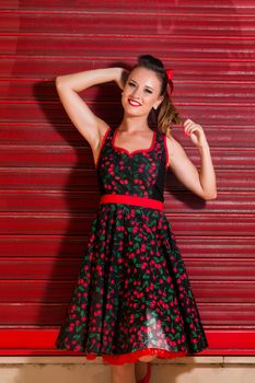 Woman posing with a vintage style retro floral clothing.