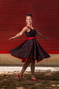 Woman posing with a vintage style retro floral clothing.