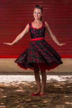 Woman posing with a vintage style retro floral clothing.