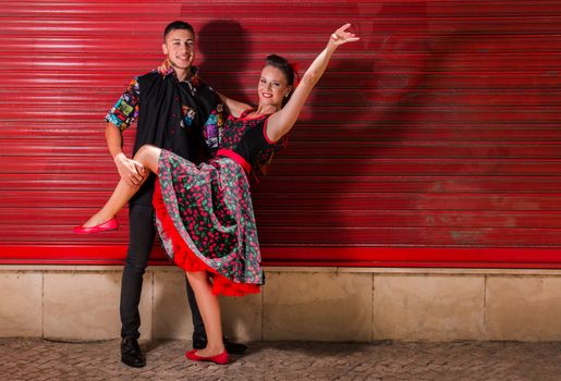 Vintage couple dancing over a red background.