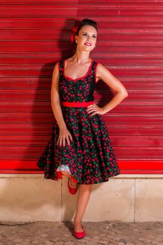 Woman posing with a vintage style retro floral clothing.