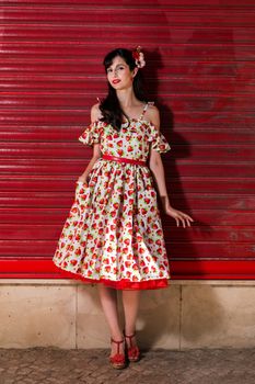 Woman posing with a vintage style retro floral clothing.