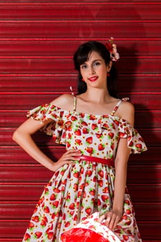 Woman posing with a vintage style retro floral clothing.